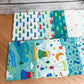 Seventeen-piece Brave Your Way fat quarter bundle by Cayla Naylor for Riley Blake Designs, featuring blue, teal, and green fabrics.