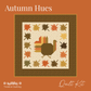 Autumn Hues quilt kit cover featuring a fall-themed quilt design with a turkey, maple leaves, and a patterned border on an orange background with Treeline Quilting branding.