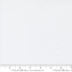 White fabric swatch with a white ruler along the bottom edge showing scale.