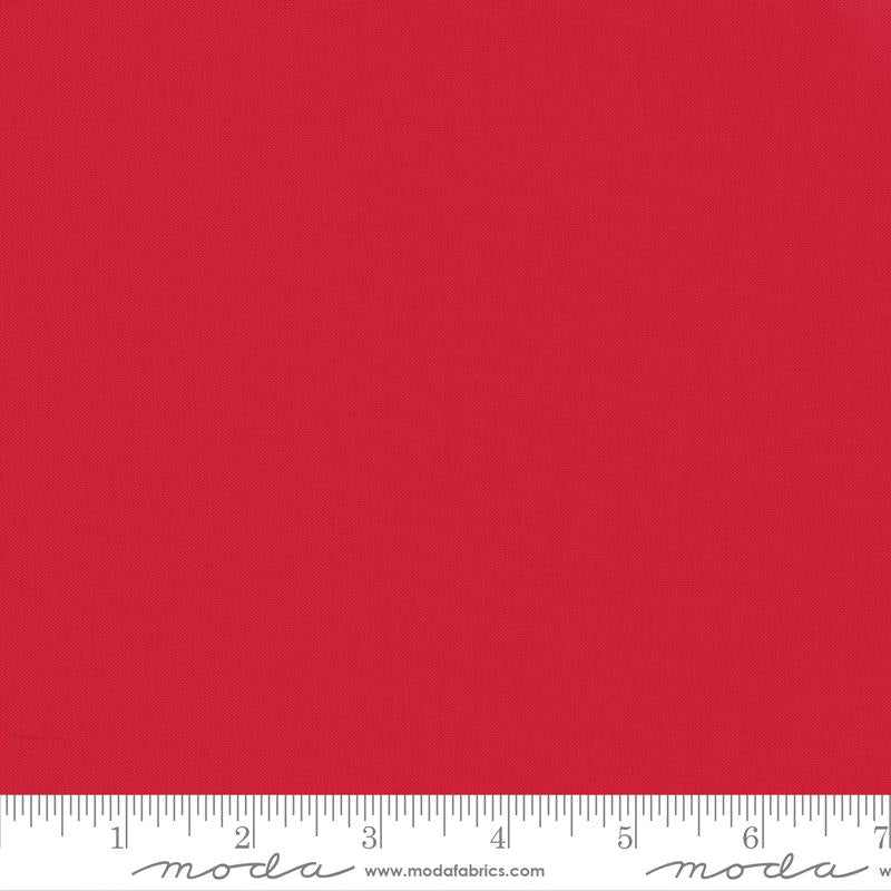 Bella solid Bettys Red fabric swatch with ruler