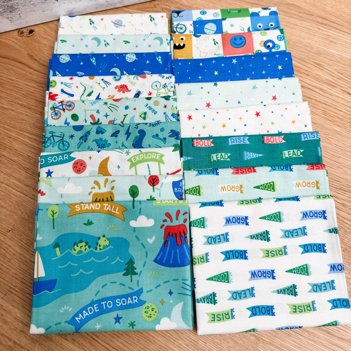 Seventeen-piece Brave Your Way fat quarter bundle by Cayla Naylor for Riley Blake Designs, featuring blue, teal, and green fabrics.