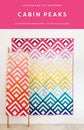Cabin Peaks quilt pattern cover by Cotton and Joy featuring a modern mountain-inspired quilt design with geometric patchwork blocks.
