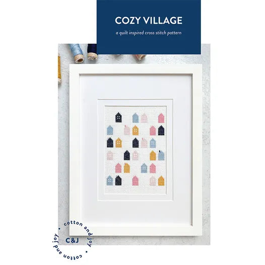 Cozy Village cross stitch with rows of houses stitched. 