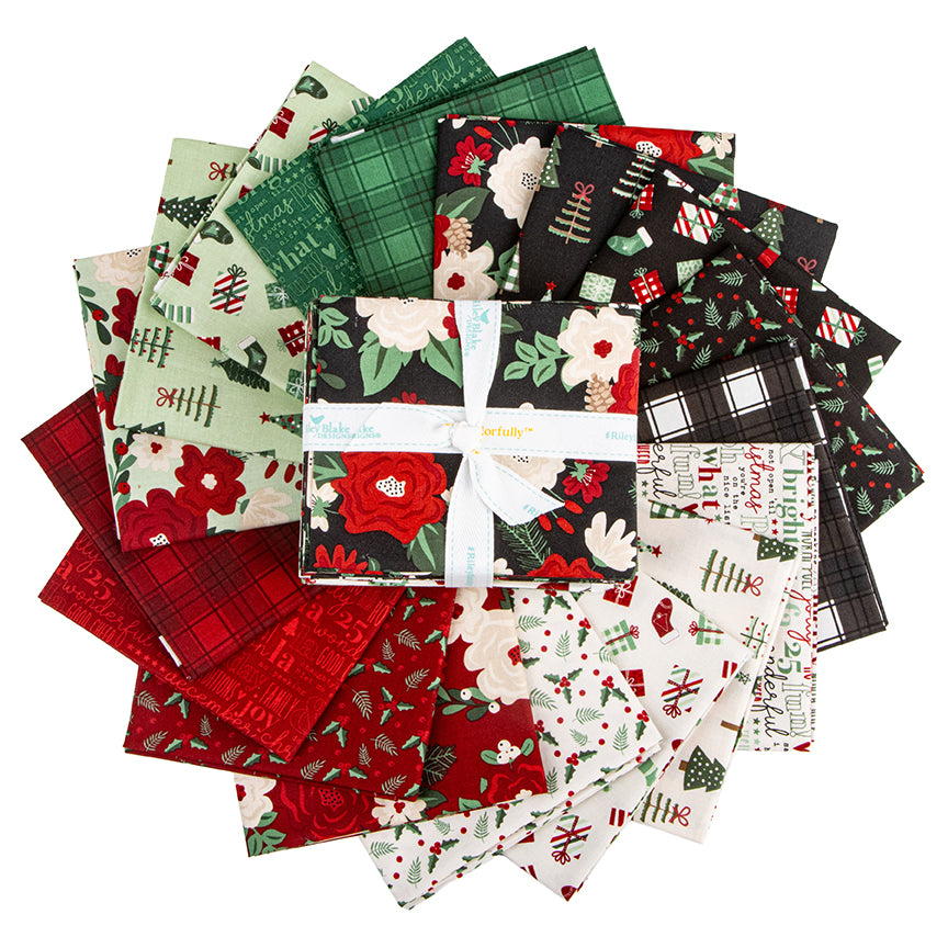 fanned out Evergreen Wishes fat quarter bundle showing the variety of Christmas prints
