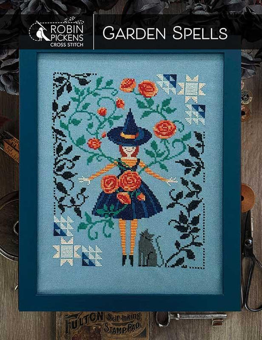 Garden Spells Cross stitch pattern cover by Robin Pickens depicting a with with a black cat, floral motif and quilt block corners.  