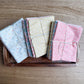 Handmade Sweetness by My Sew Quilty Life for Moda Fabrics petite fat quarter bundles in Multi, Peach, and Butterscotch, tied and displayed side by side on a tray.
