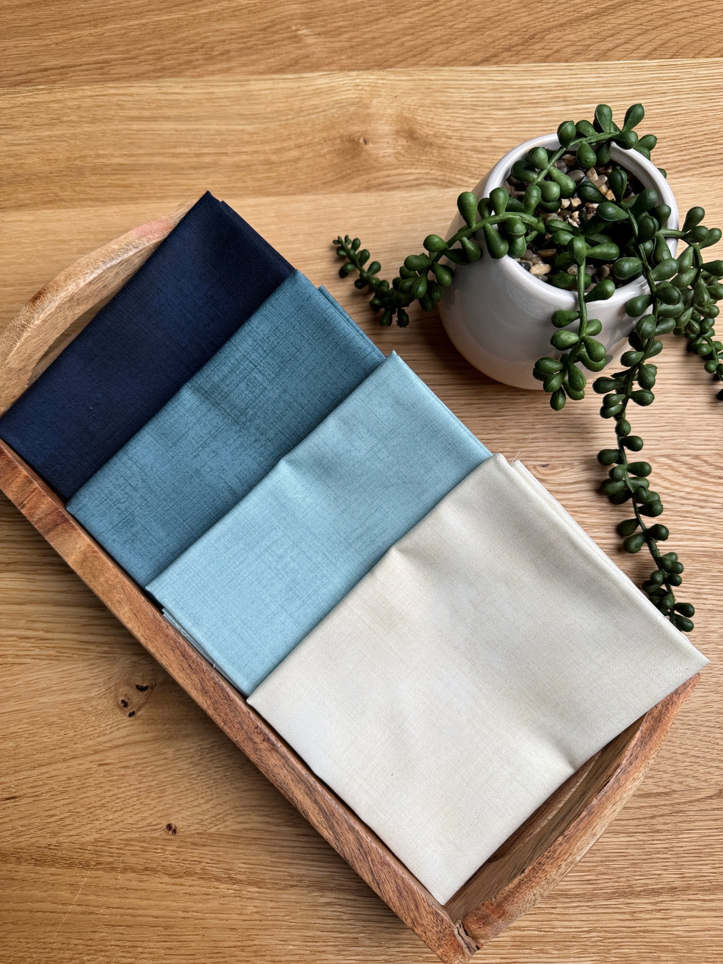 4 pack of fat quarters.  The cream, light blue, medium blue, and dark blue blenders from the Data collection by Janet Clare for Moda Fabrics