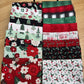 Evergreen Wishes fat quarters spread out on a tray showing the variety of Christmas prints