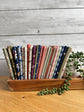 Flat lay of the Hedgerow Haven 24-piece fat quarter bundle by Amber Elliot of Alderwood Studio for Riley Blake Designs