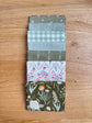 Flat lay of the Green Hedgerow Haven petite fat quarter bundle, 8 fat quarters by Amber Elliot of Alderwood Studio for Riley Blake Designs