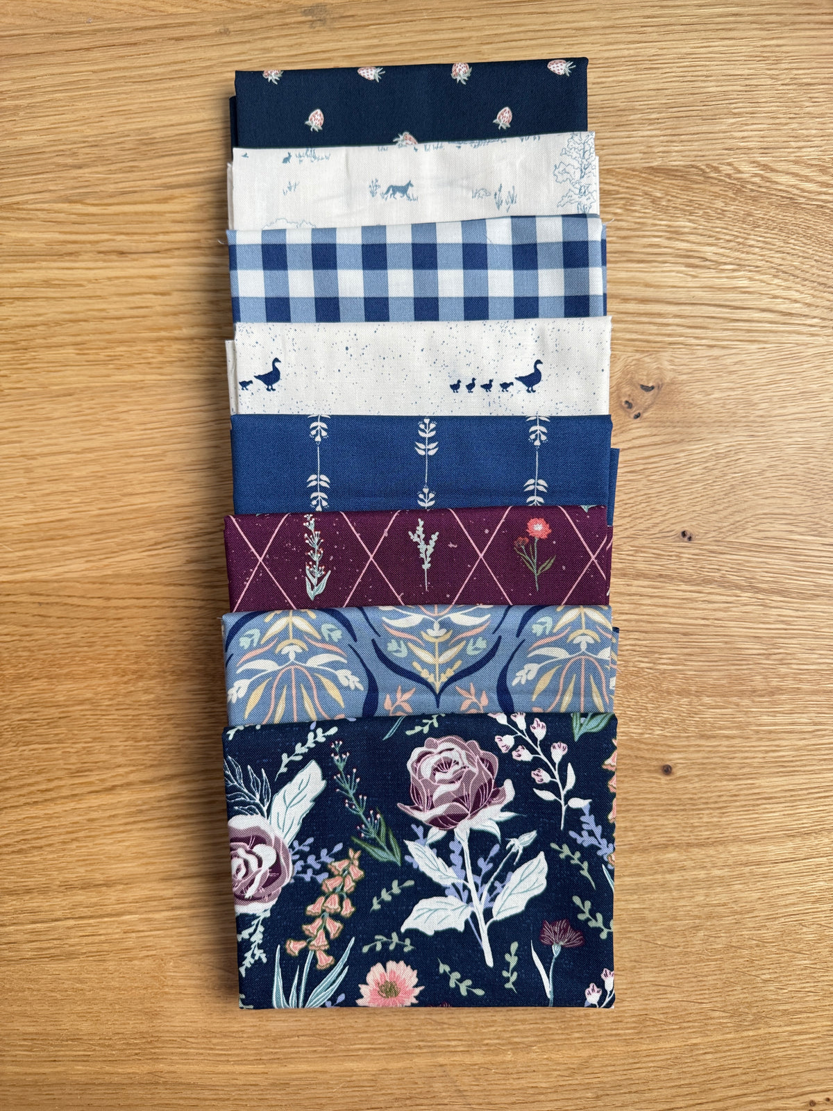 Flat lay of the Blue Hedgerow Haven petite fat quarter bundle, 8 fat quarters by Amber Elliot of Alderwood Studio for Riley Blake Designs