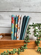 Wedgewood Where the Wild Flowers Are petite fat quarter bundle standing on end on a wooden tray next to a plant