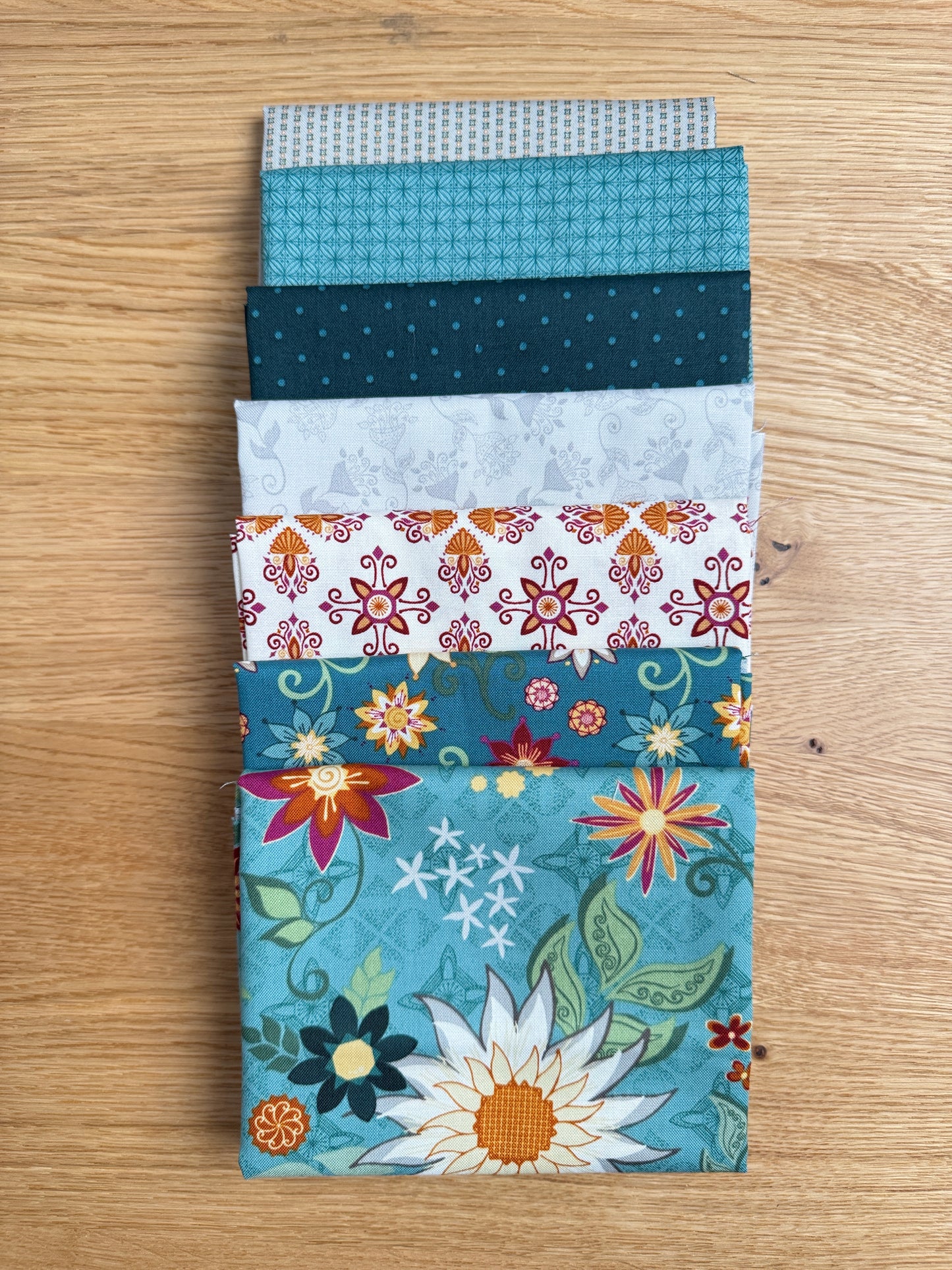 Flat lay of the Wedgewood Where the Wild Flowers Are petite fat quarter bundle, 7 fat quarters by Judi Madsen for Riley Blake Designs