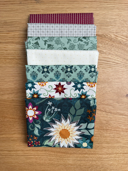 Flat lay of the Dark Teal Where the Wild Flowers Are petite fat quarter bundle, 7 fat quarters by Judi Madsen for Riley Blake Designs