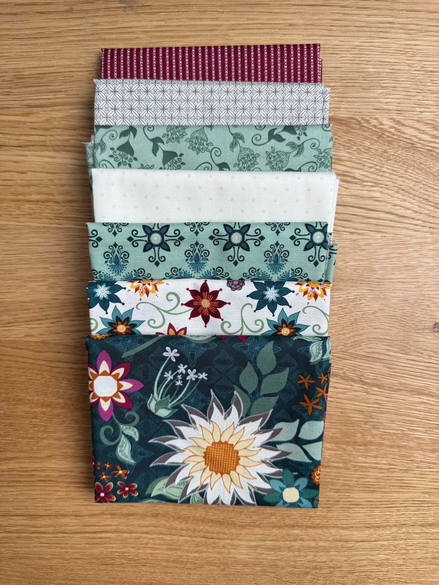 Flat lay of the Dark Teal Where the Wild Flowers Are petite fat quarter bundle, 7 fat quarters by Judi Madsen for Riley Blake Designs