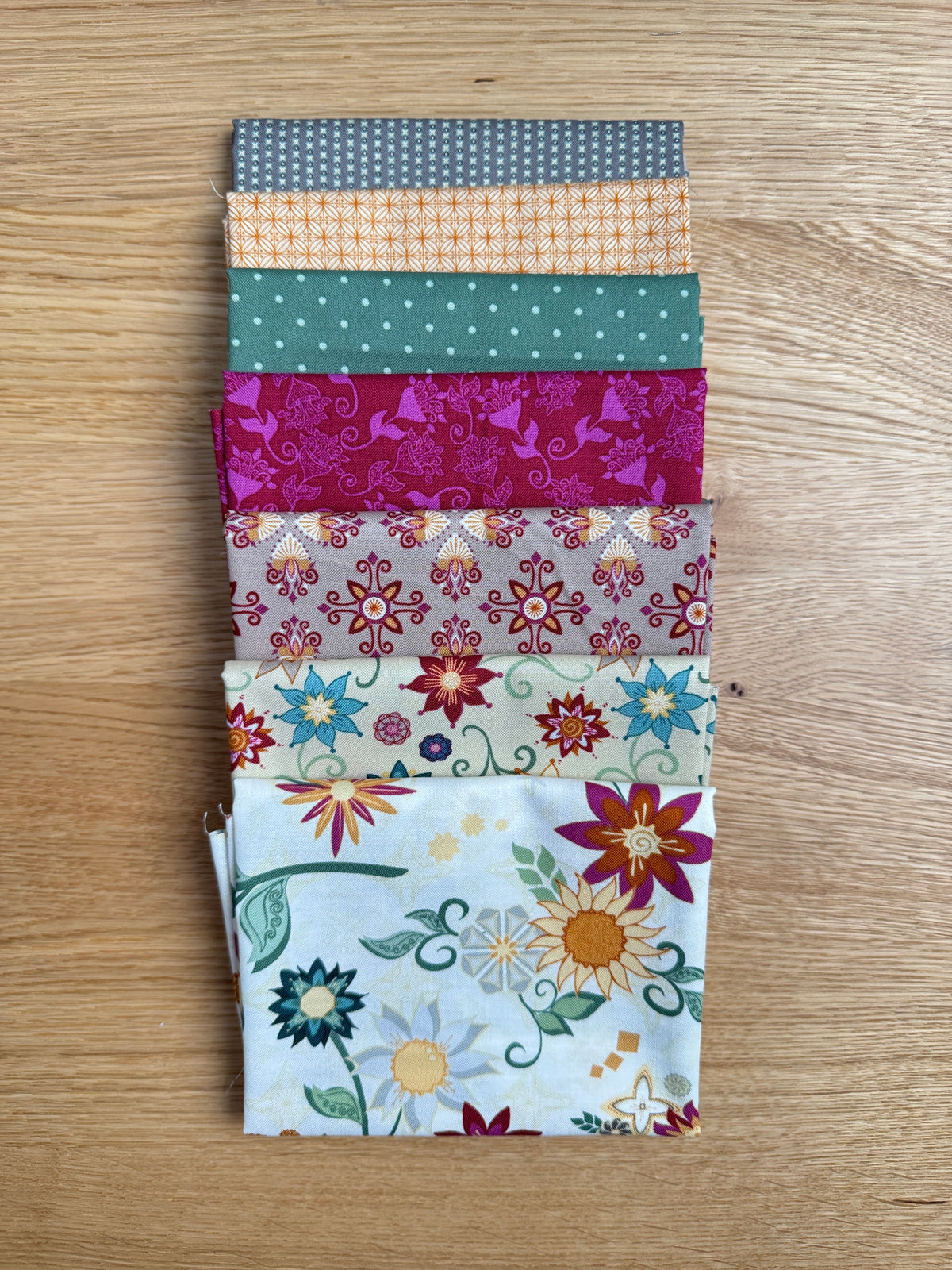 Flat lay of the Cream Where the Wild Flowers Are petite fat quarter bundle, 7 fat quarters by Judi Madsen for Riley Blake Designs
