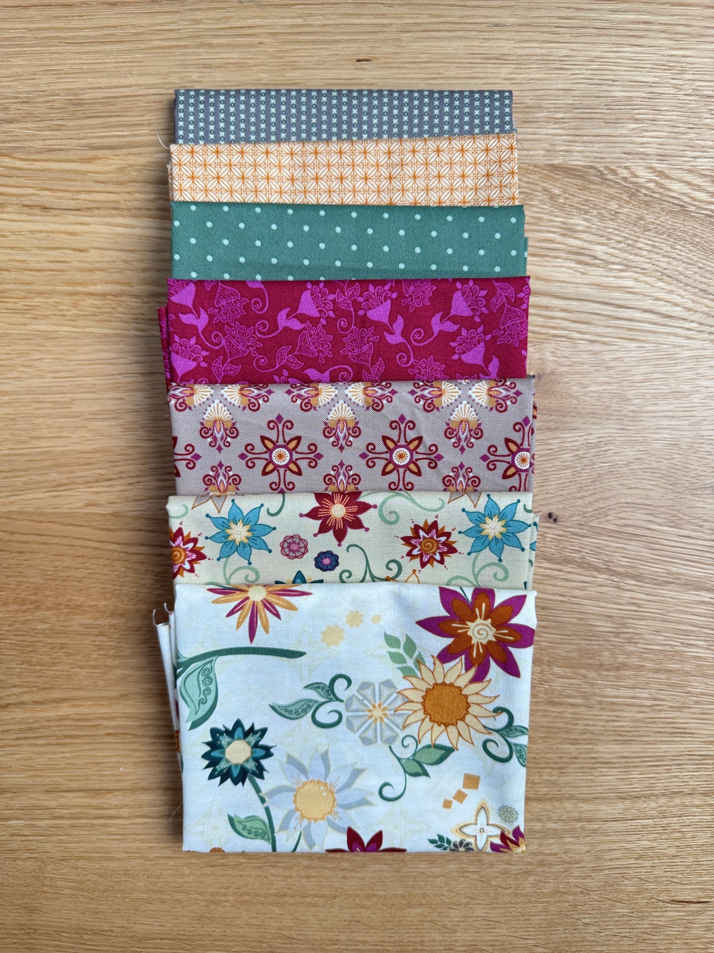 Flat lay of the Cream Where the Wild Flowers Are petite fat quarter bundle, 7 fat quarters by Judi Madsen for Riley Blake Designs