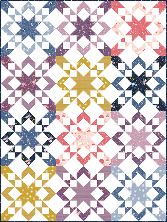 Finished Starly quilt featuring repeating star blocks arranged in a modern layout with coordinated fabrics on a light background.
