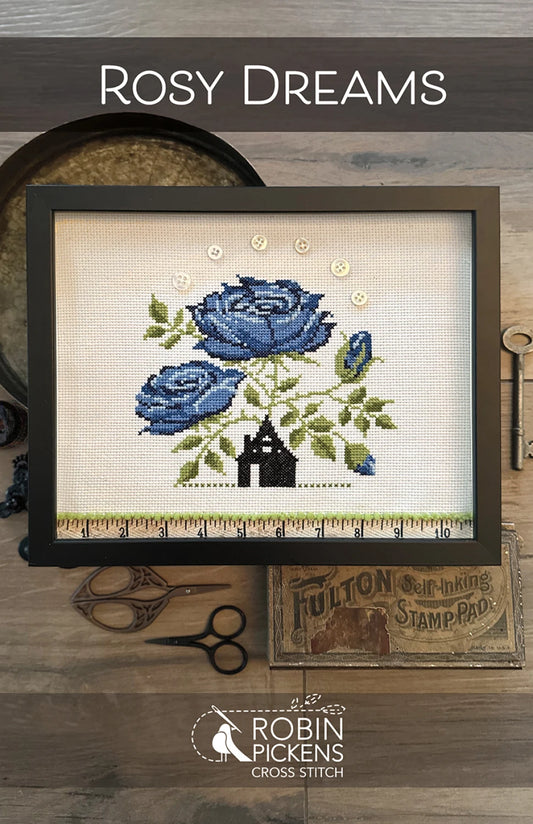 Rosy Dreams Cross Stitch Pattern cover by Robin Pickens.  Black house with large blue flowers erupting from the top of the house. 