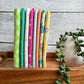 Joysome Sunshine 8-piece fat quarter bundle in yellow tones, displayed standing on edge on a decorative tray beside a faux plant.