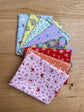 Traditional 30's fat quarters in blue, pink, red, purple, orange, and yellow prints by Lindsay Wilkes for Riley Blake Designs.