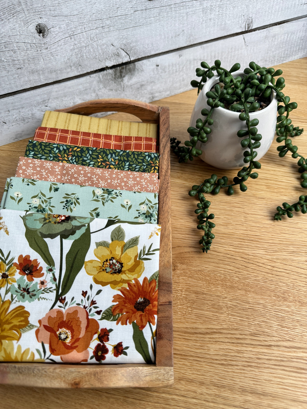Stylized photo of 6 fat quarters from Worth Repeating fabric collection with the Cloud  main print .