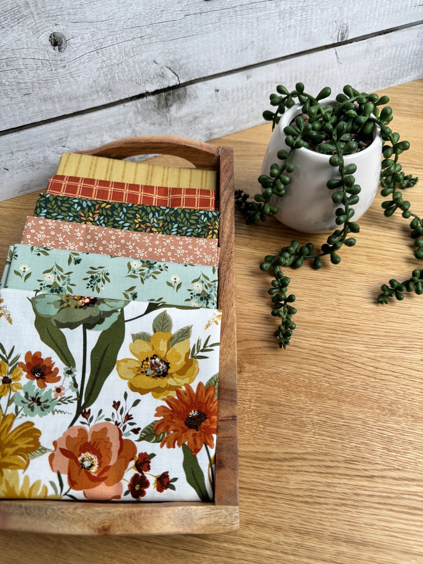 Stylized photo of 6 fat quarters from Worth Repeating fabric collection with the Cloud  main print .