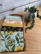 Stylized photo of 6 fat quarters from Worth Repeating fabric collection with the Laurel  main print .  