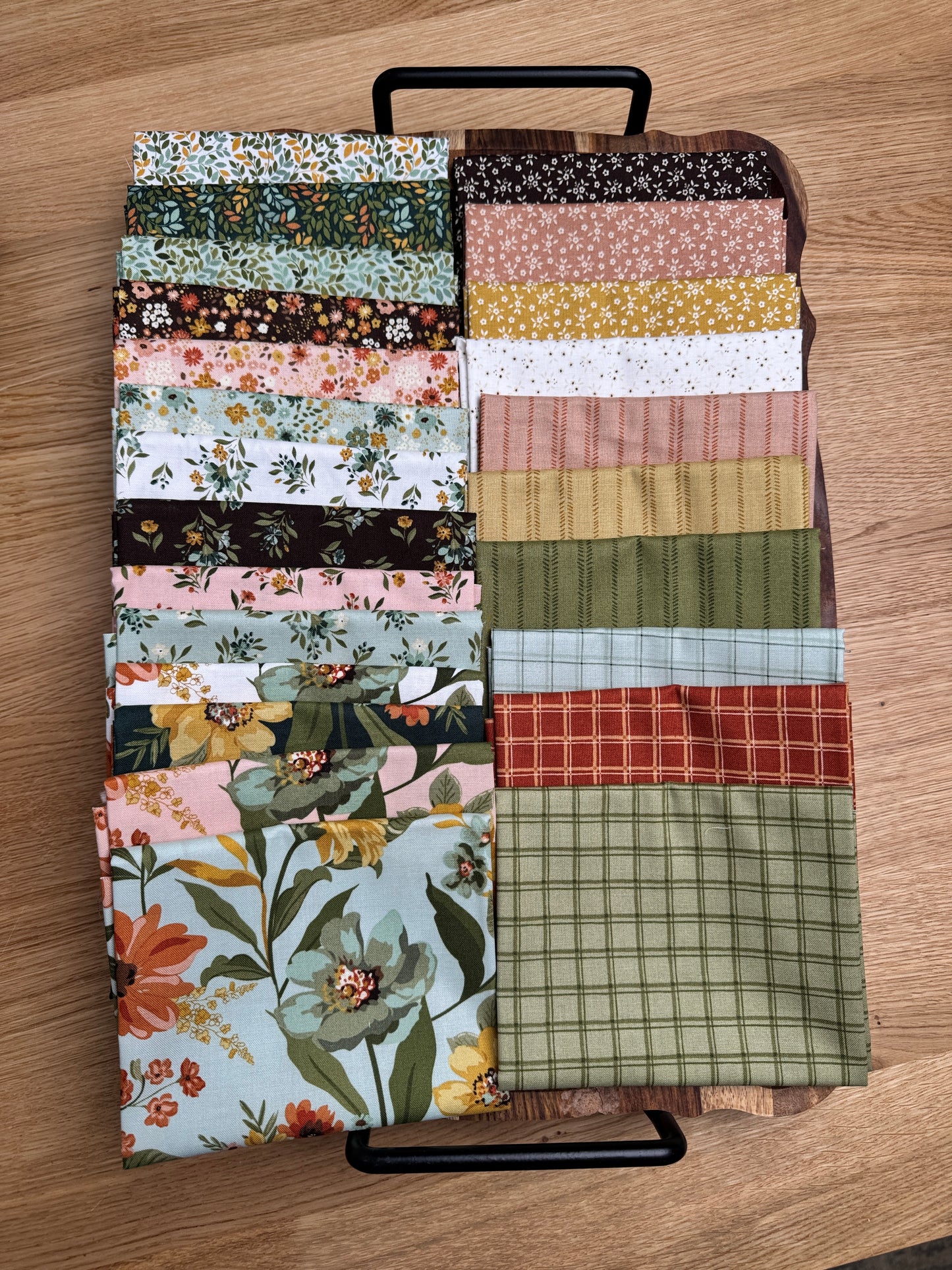 24 piece fat quarters of Worth Repeating fabric laid out on a tray.  