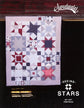 A quilted patchwork textile displayed flat against a dark background, featuring star and geometric block patterns in white, light blue, navy, and red. The image includes visible branding text reading 'Sweetwater' at the top right and 'Seeing Stars' with size and item number at the bottom right.
